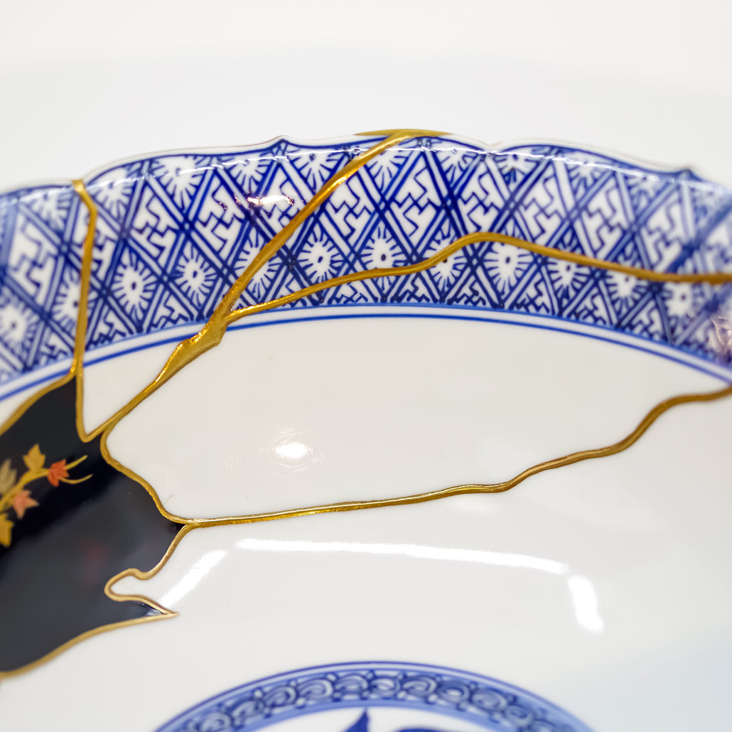 Detail of intricate gold Kintsugi repair on ceramic.