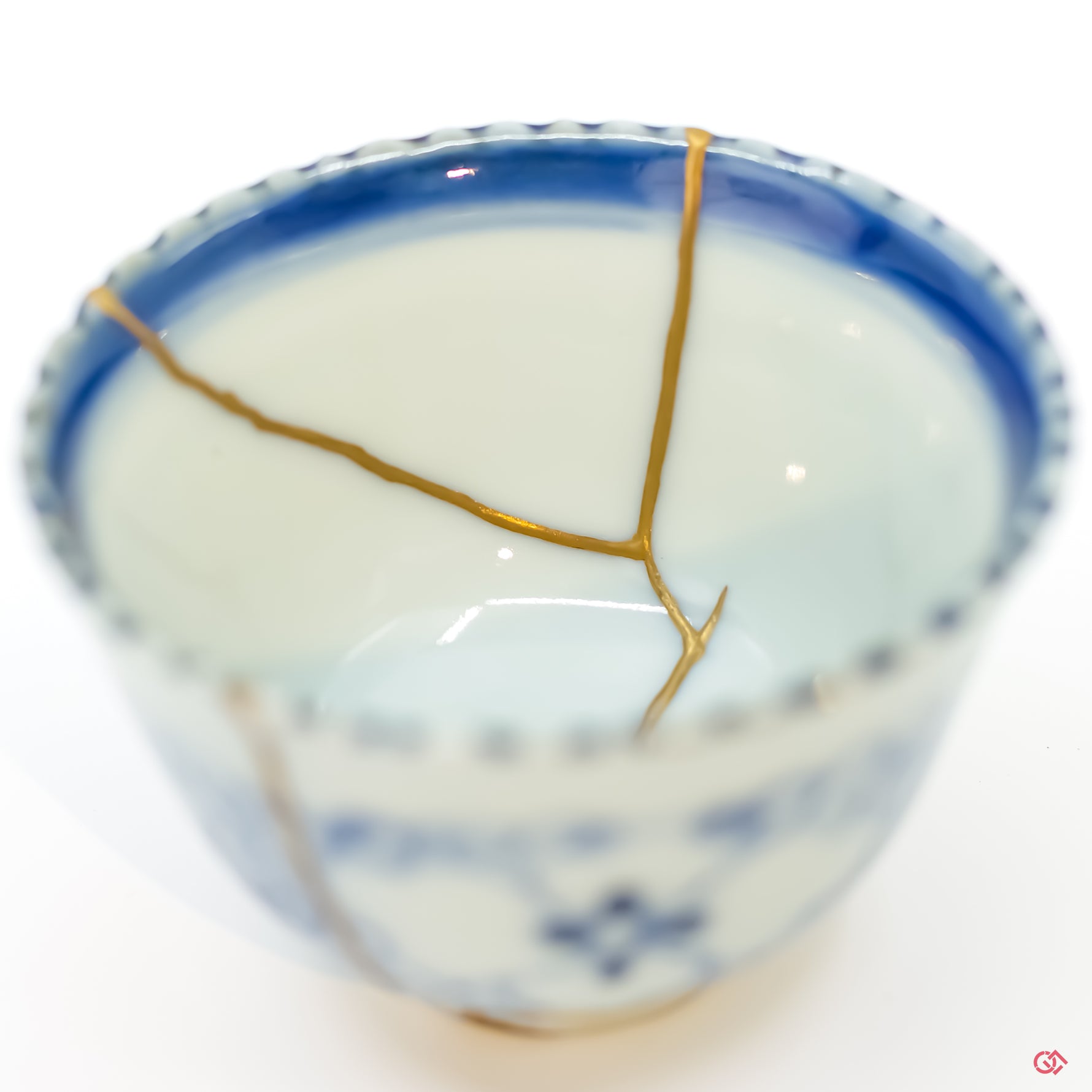 Detailed close-up of authentic Kintsugi pottery, showcasing the delicate gold lines of the repair and the artisan's craftsmanship.