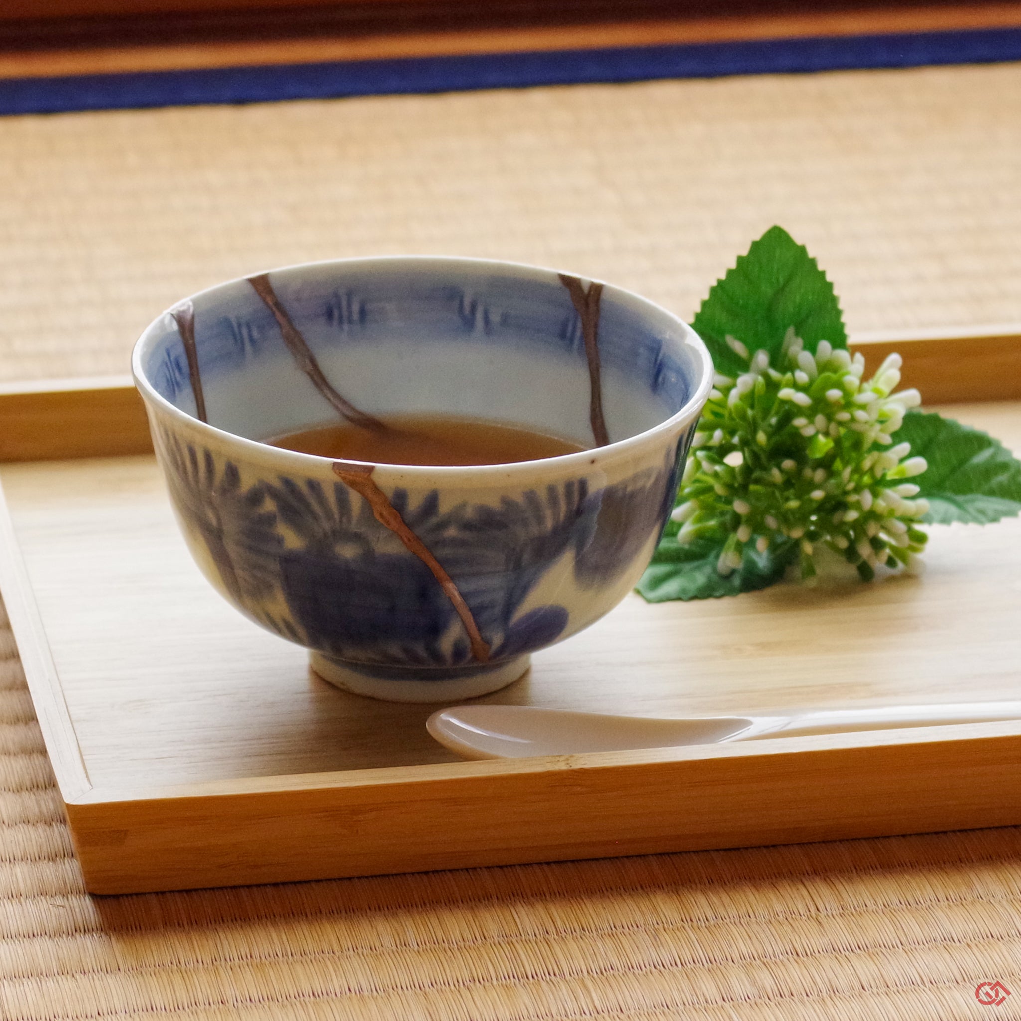A photo of an authentic Kintsugi pottery piece being used in a real-world setting, such as a cup of soup being poured into a Kintsugi cup.