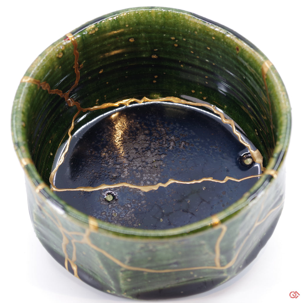 Close-up photo of an authentic Kintsugi pottery piece, showing the detail of its repairs and craftsmanship