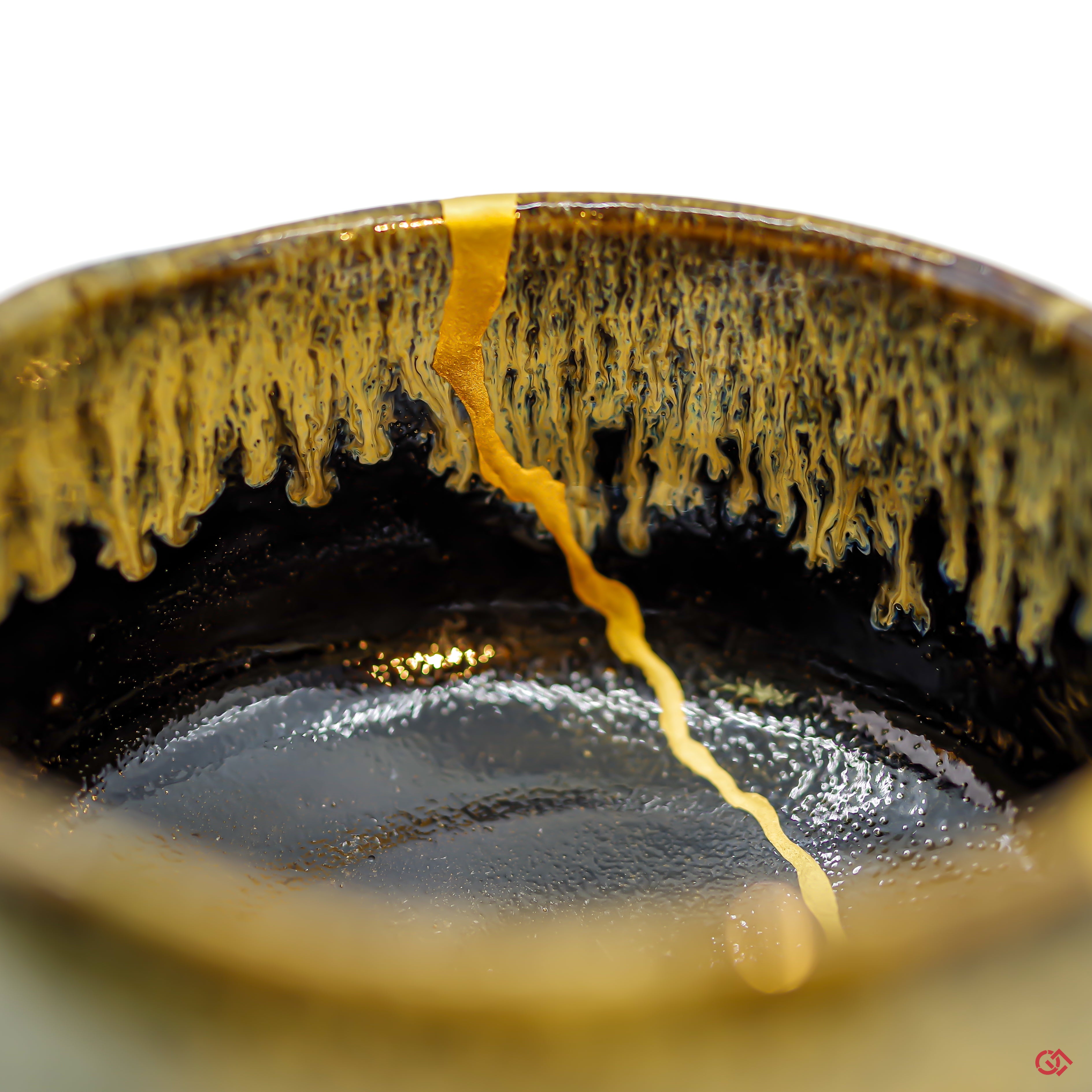 Appreciate the artistry of Kintsugi: Detailed image of pure gold filled cracks in pottery.