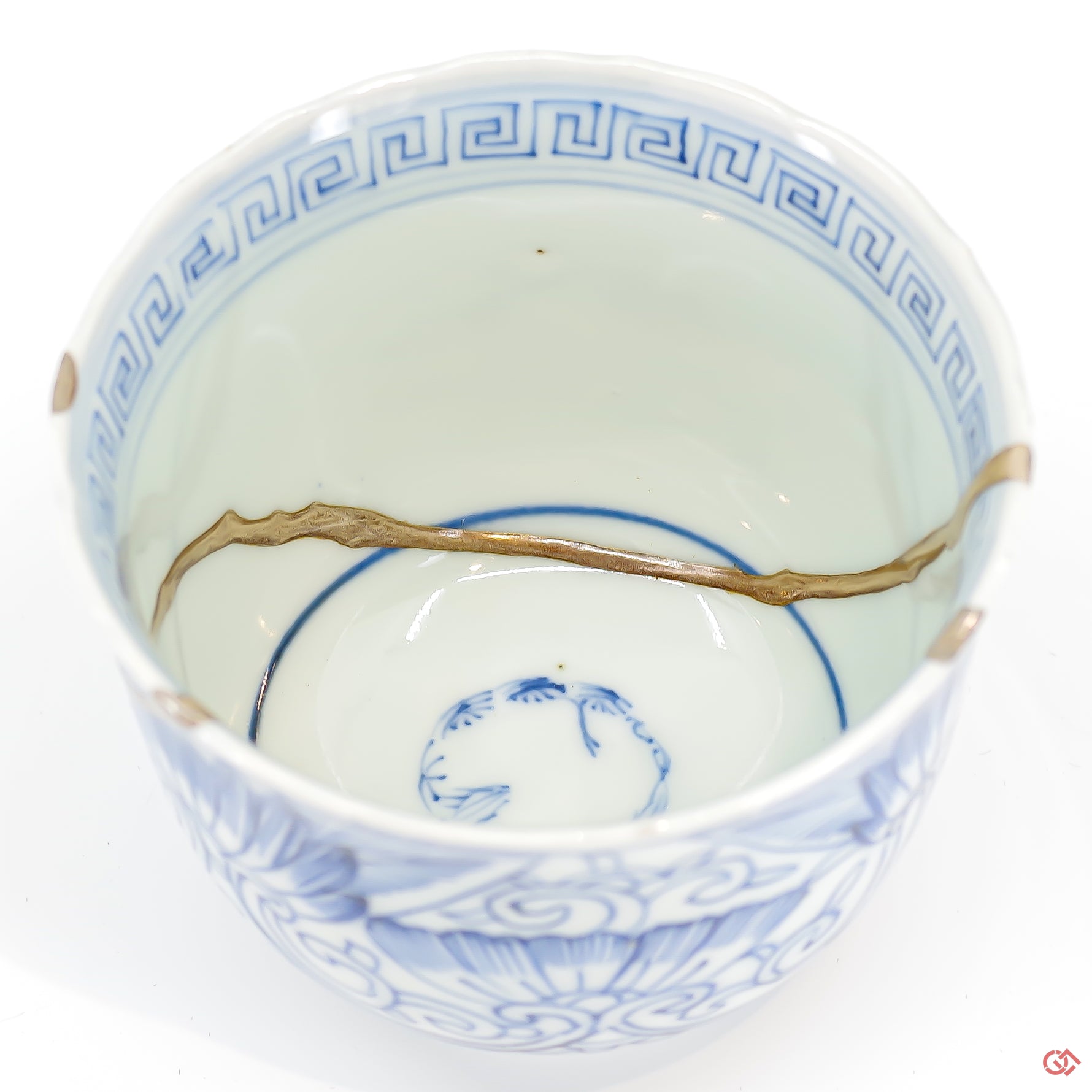 A close-up photo of an authentic Kintsugi pottery piece, showing the detail of its repairs and craftsmanship.