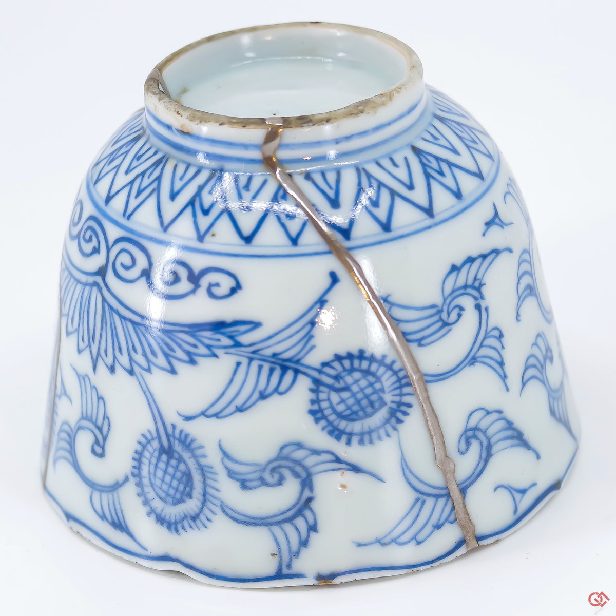 A close-up photo of an authentic Kintsugi pottery piece, showing the detail of its repairs and craftsmanship.