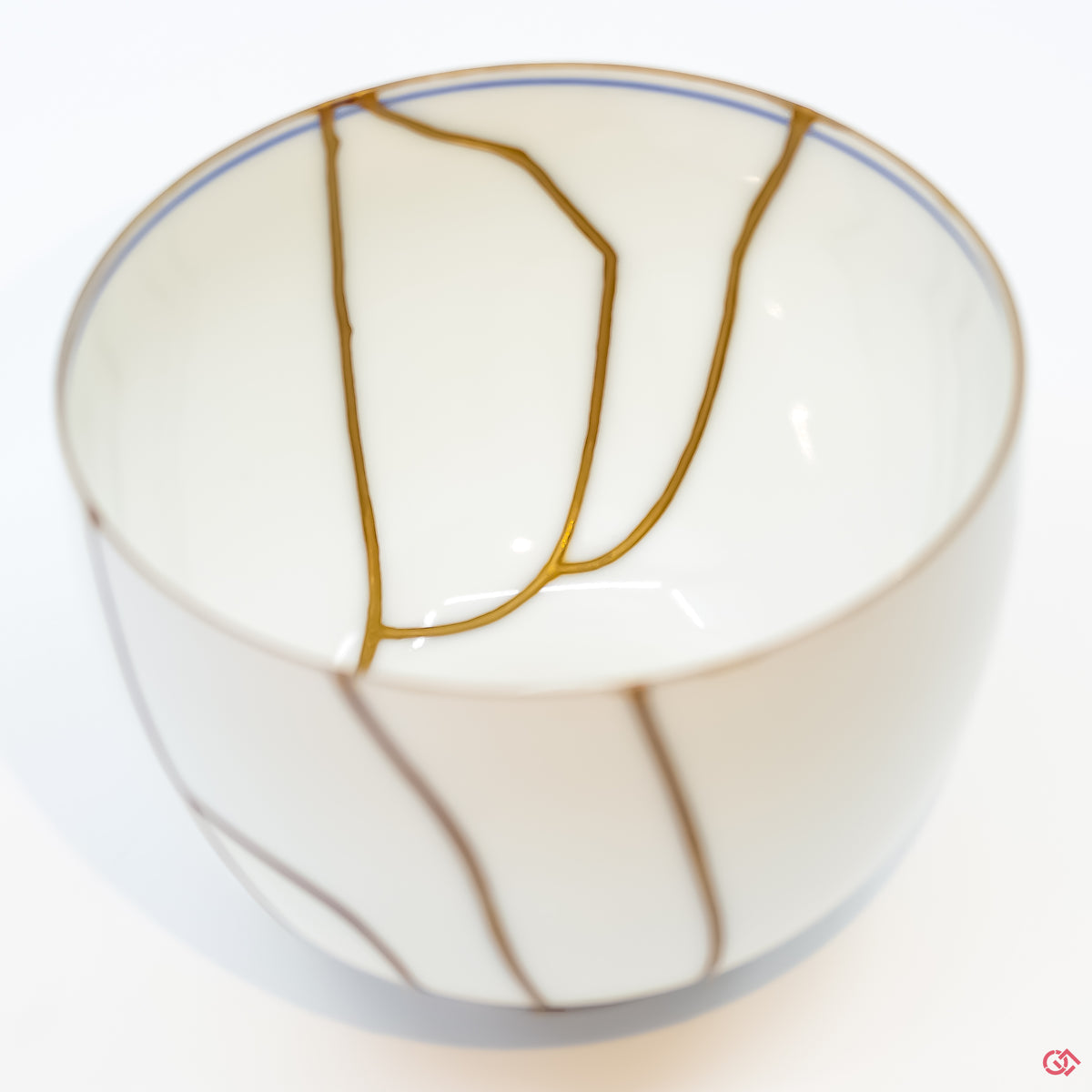 Close-up photo of an authentic Kintsugi pottery piece, showing the detail of its repairs and craftsmanship