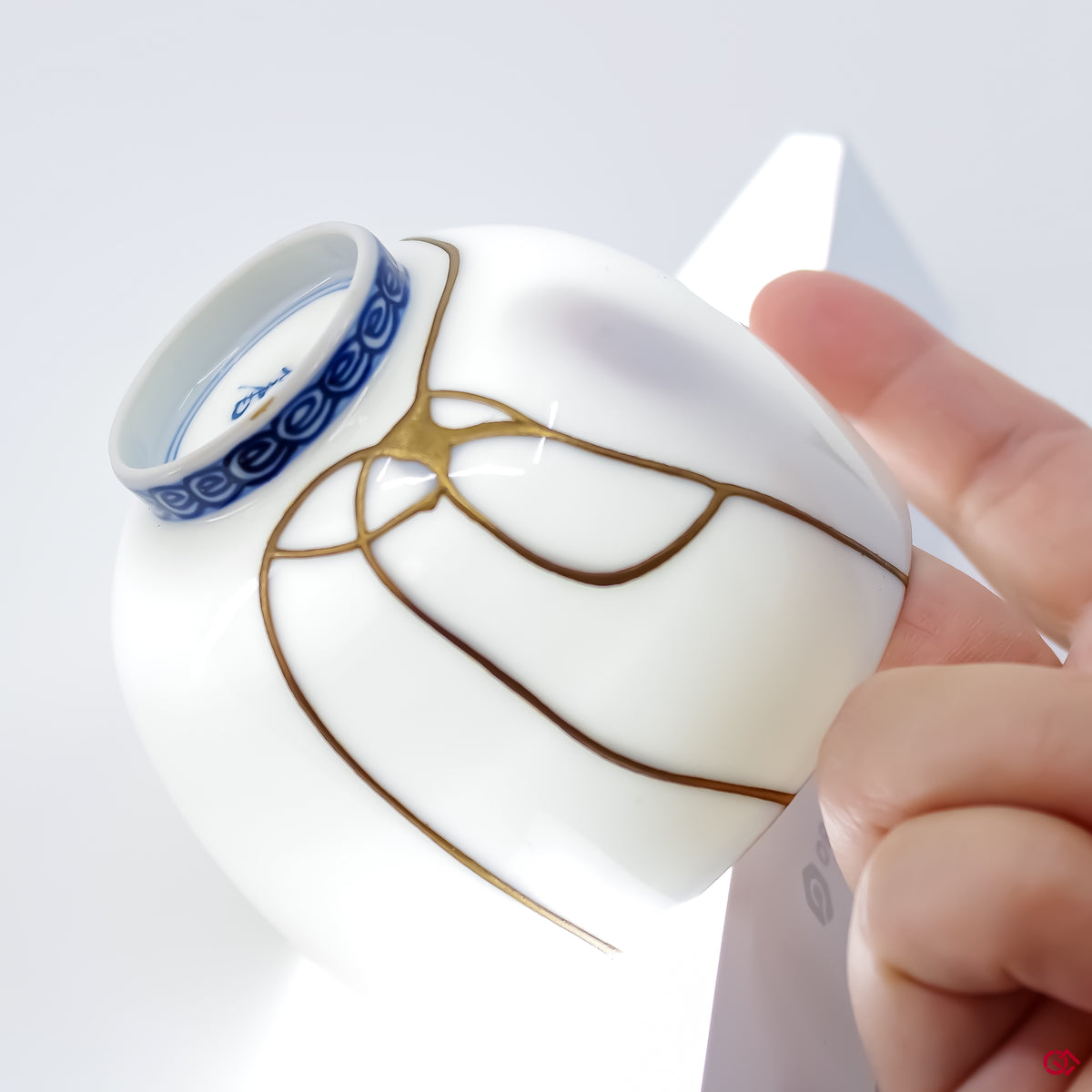 Close-up photo of an authentic Kintsugi pottery piece, showing the detail of its repairs and craftsmanship