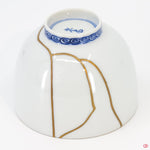 Close-up photo of an authentic Kintsugi pottery piece, showing the detail of its repairs and craftsmanship