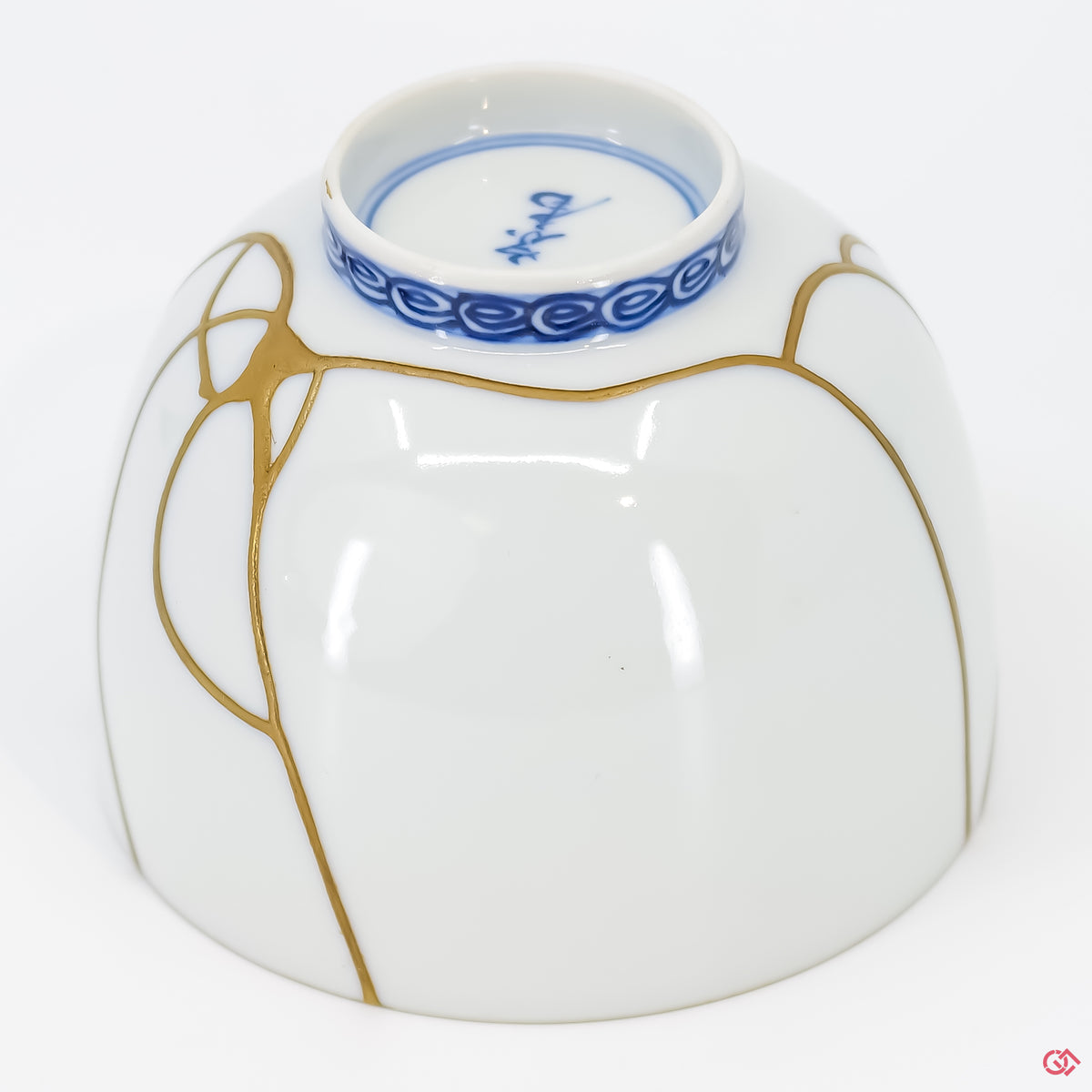 Close-up photo of an authentic Kintsugi pottery piece, showing the detail of its repairs and craftsmanship