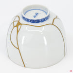 Close-up photo of an authentic Kintsugi pottery piece, showing the detail of its repairs and craftsmanship