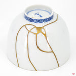 Close-up photo of an authentic Kintsugi pottery piece, showing the detail of its repairs and craftsmanship