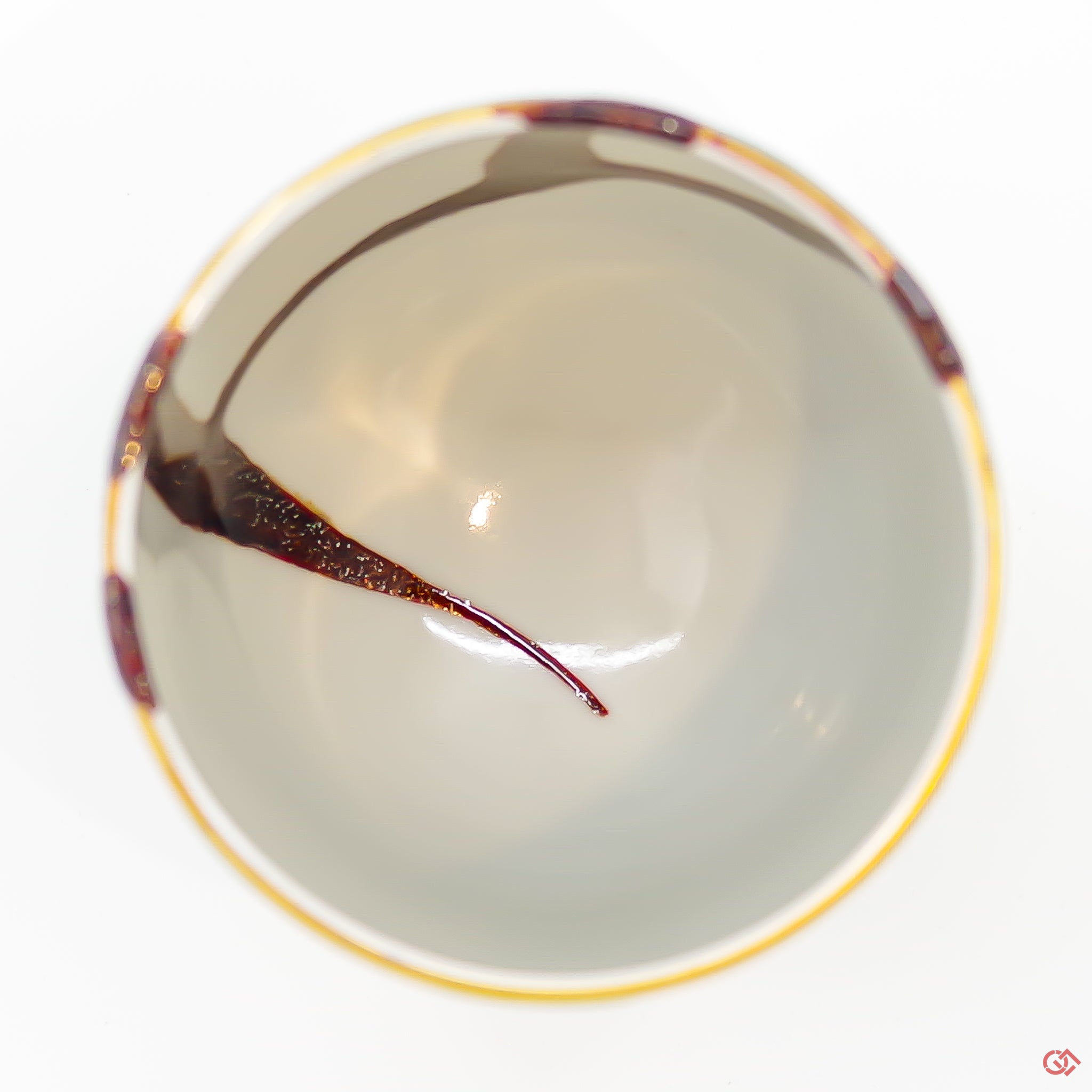 A photo of the top side of an authentic Kintsugi pottery piece, showing its overall design and features.