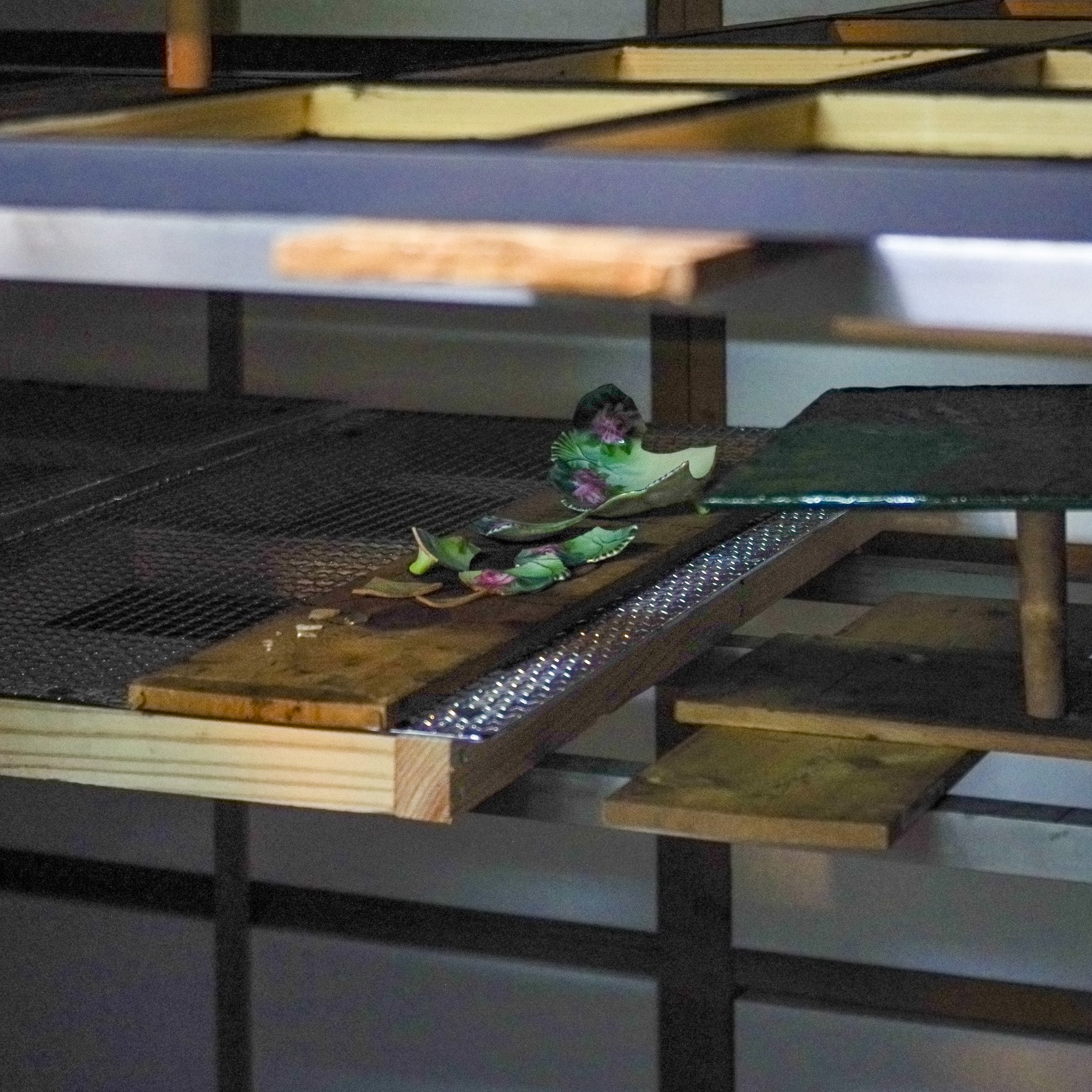 Restored bowl pieces resting inside the urushi-muro, a traditional Japanese humidity-controlled curing chamber where urushi lacquer hardens slowly