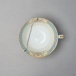 Kintsugi tea cup in Early Noritake porcelain, seen from above: a single 24K gold line in natural urushi crosses the interior well from rim to rim.
