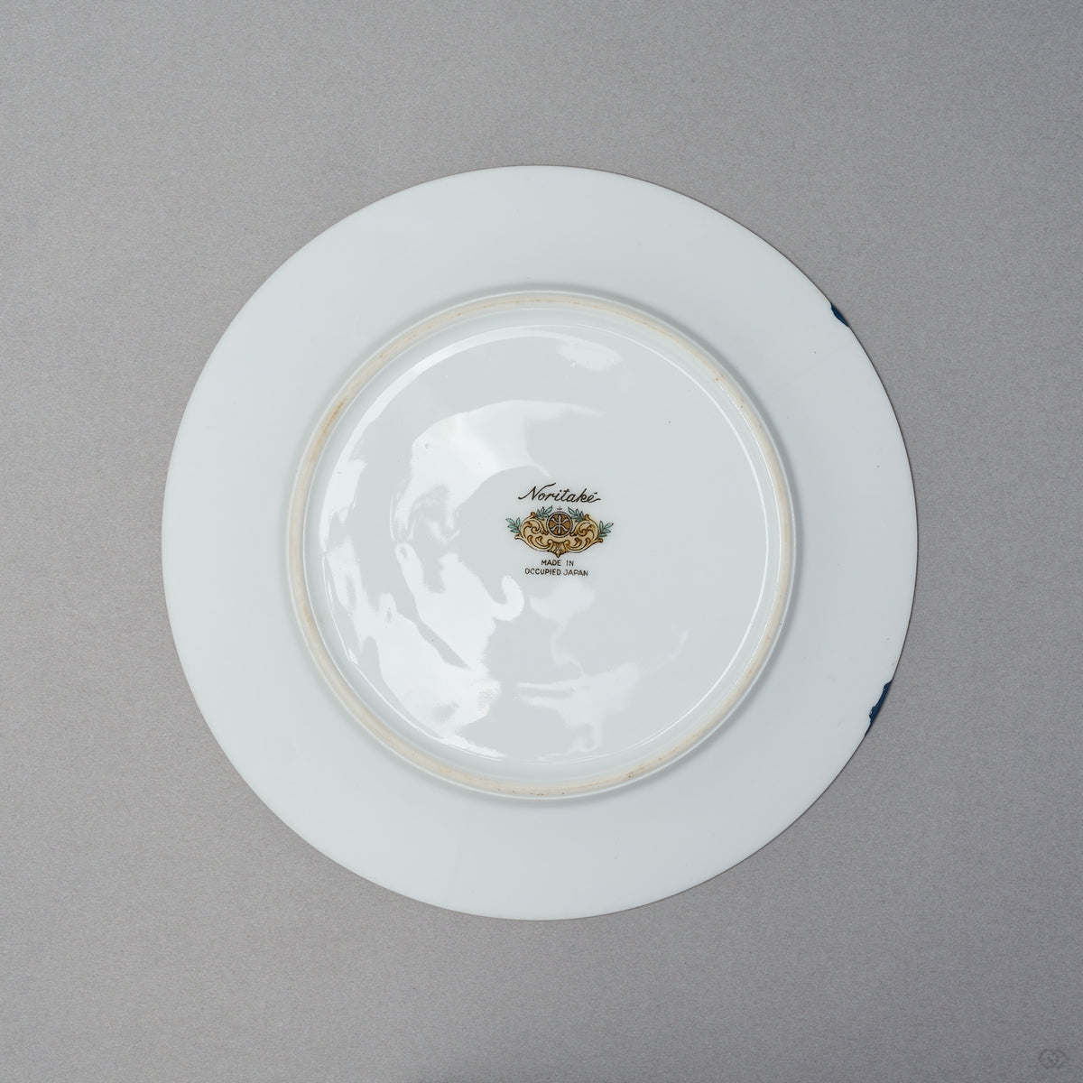 Kintsugi tea cup and saucer, Early Noritake saucer underside with backstamp; restored in natural urushi, 24K gold on the cup, blue urushi at the rim.