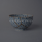 Kintsugi tea cup in Kyoto ware covered in sometsuke cherry blossoms, restored with natural urushi and 24K gold, front view. Collected.