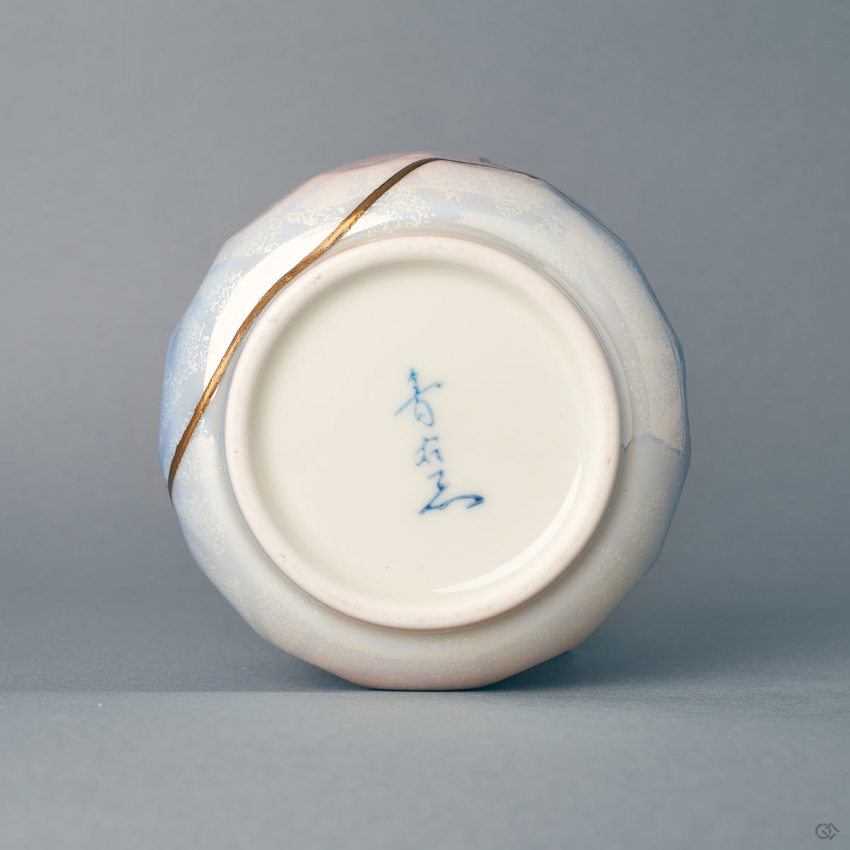 The foot and base of the Arita kintsugi bowl, where the pastel glaze ends — evidence of slow craft in porcelain and urushi.