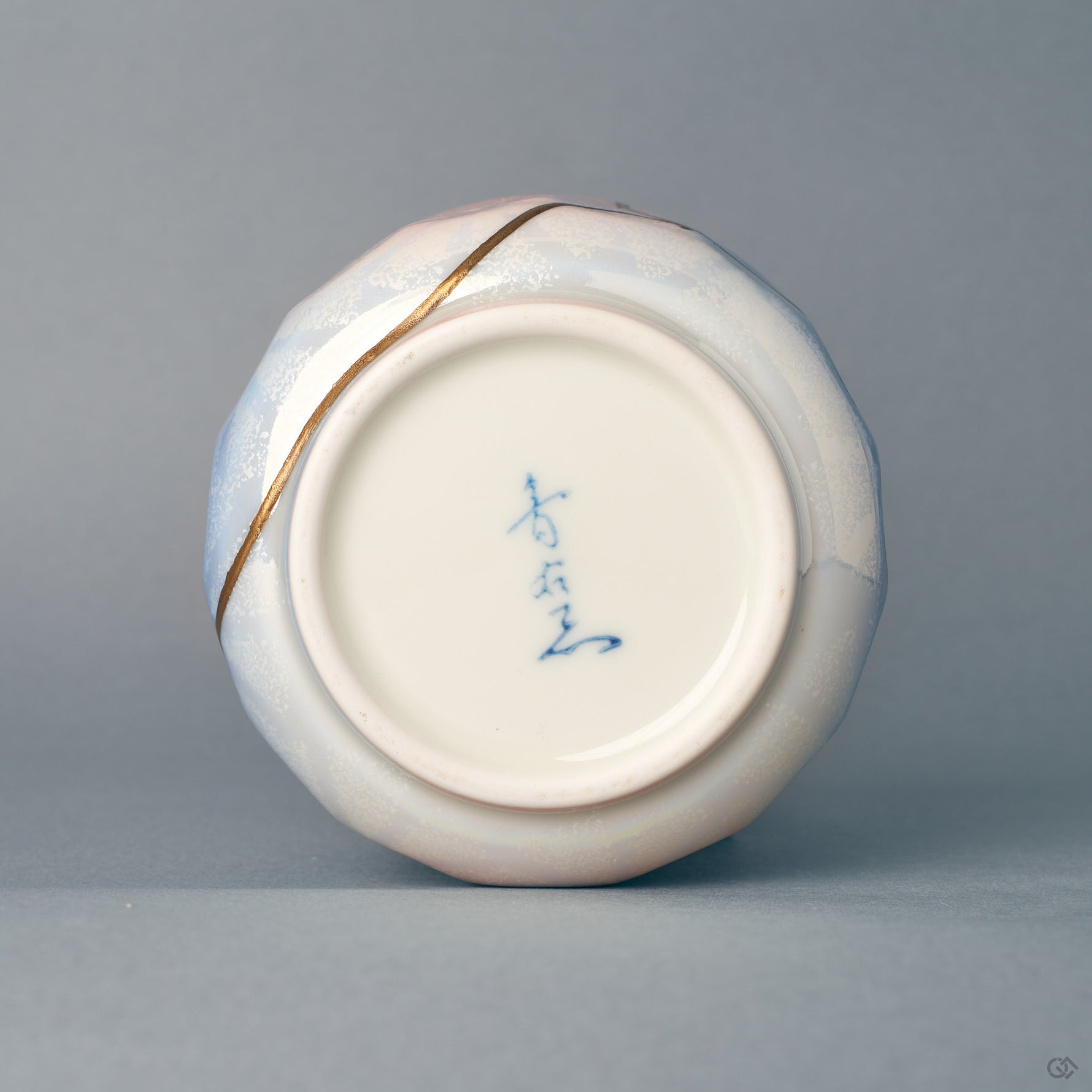The foot and base of the Arita kintsugi bowl, where the pastel glaze ends — evidence of slow craft in porcelain and urushi.