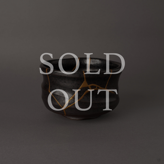 Sold out: Kintsugi Arita matcha bowl in dark charcoal glaze with branching 24K gold seams, restored with natural urushi lacquer.