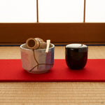 The kintsugi matcha bowl resting on tatami, its gold seams soft in daylight, a small note of intentional living in a tea setting.
