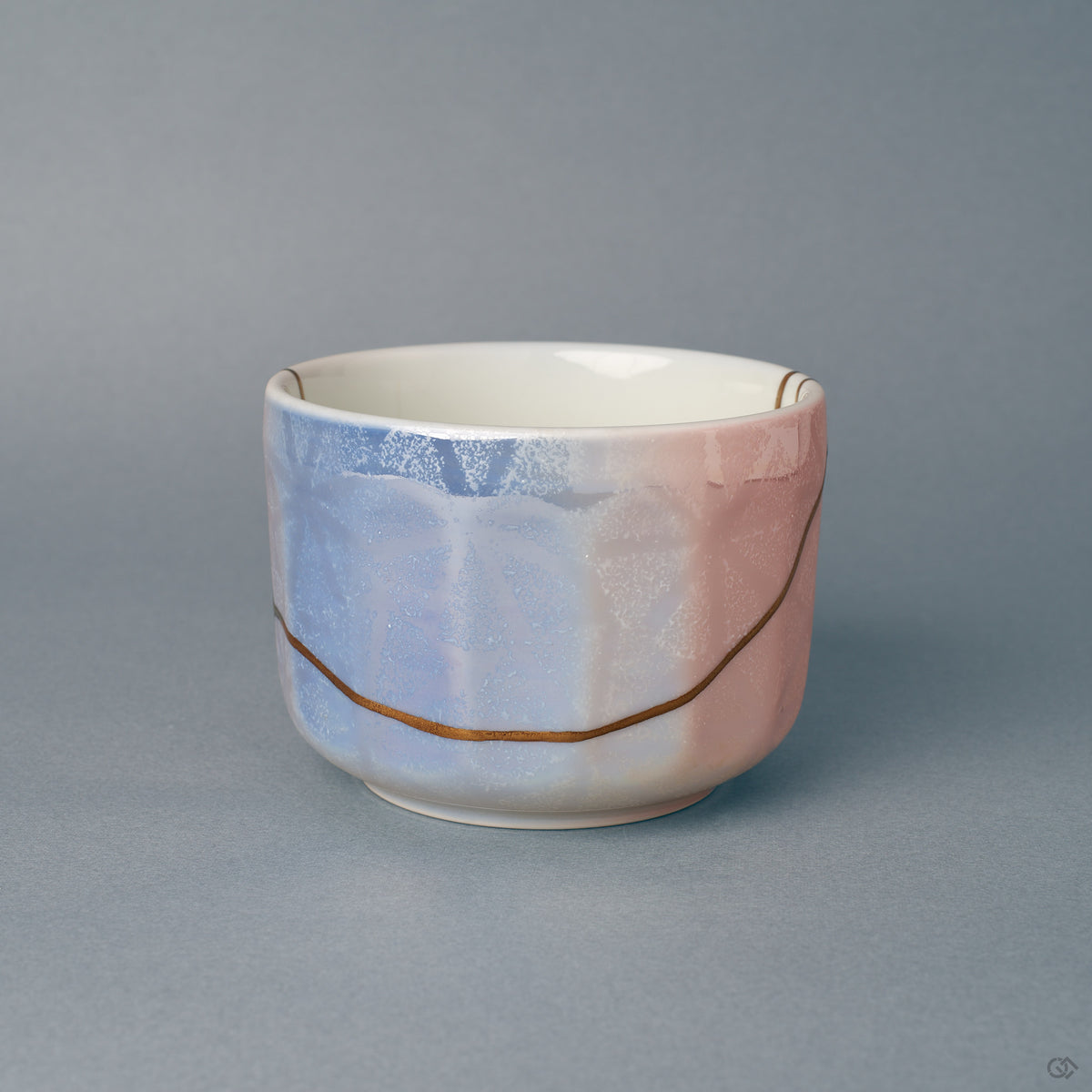 The blush-pink side of this rounded matcha bowl, a gold kintsugi seam following it, one-of-a-kind in glaze and restoration.