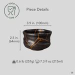 Kintsugi Arita matcha bowl with diameter, height, and weight measurements overlaid on the front view, gold seams across dark glaze.