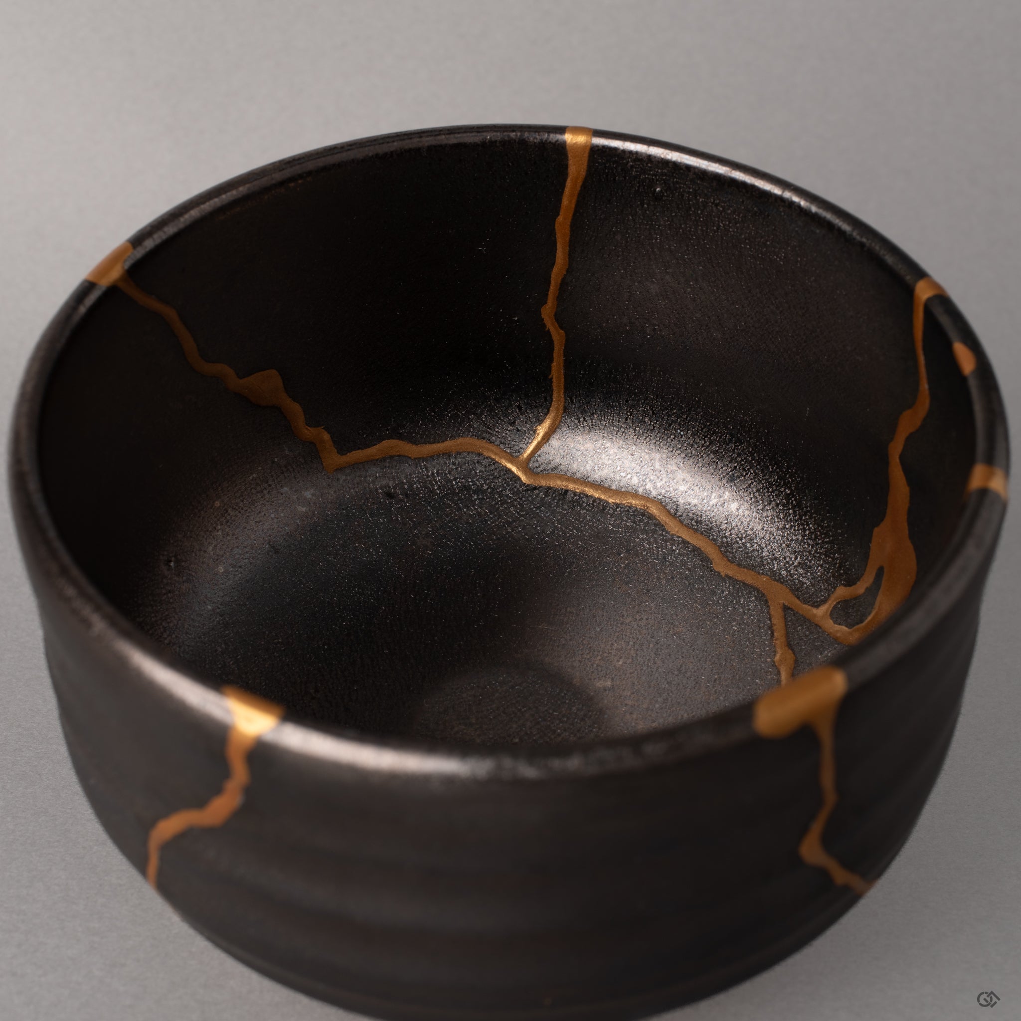 Kintsugi lines converge within this Arita matcha bowl, gold paths mapping where fractures met urushi, philosophy in form.