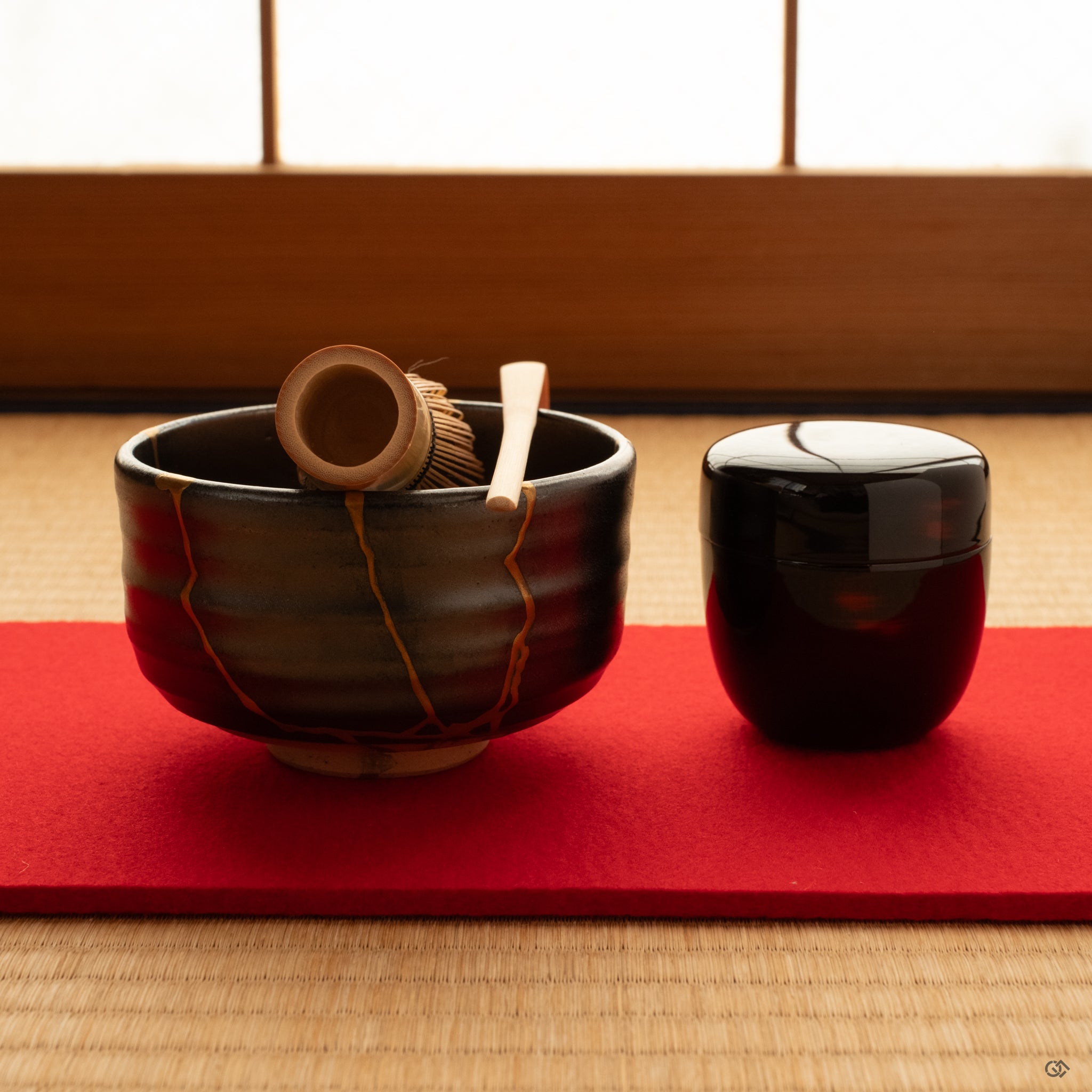 Morning calm on tatami as the dark Arita kintsugi bowl rests in stillness, gold seams quiet in soft light, mindful luxury at rest.