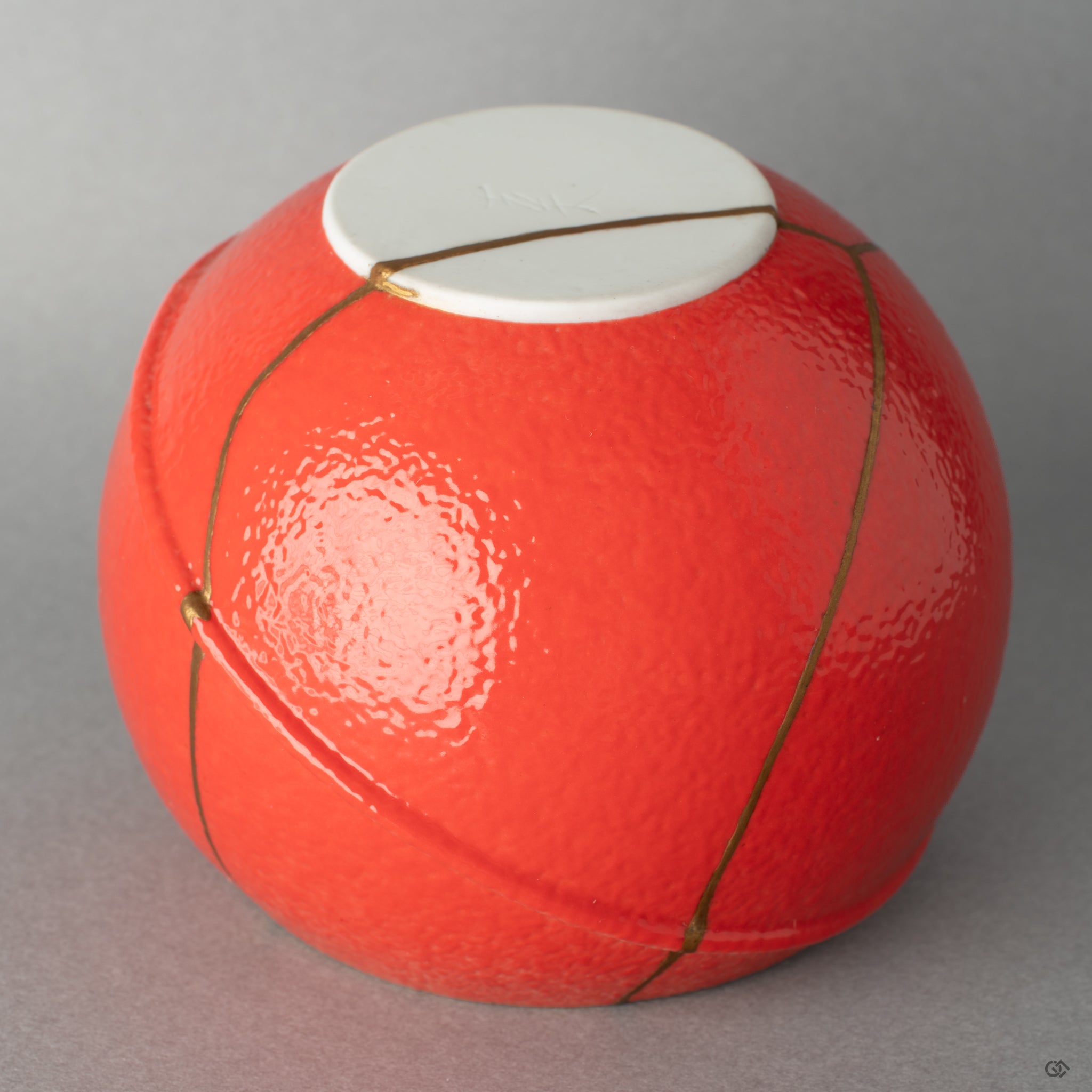 A macro view of the gold repair line, highlighting the kintsugi artistry that finds grace in flaws rather than hiding them.