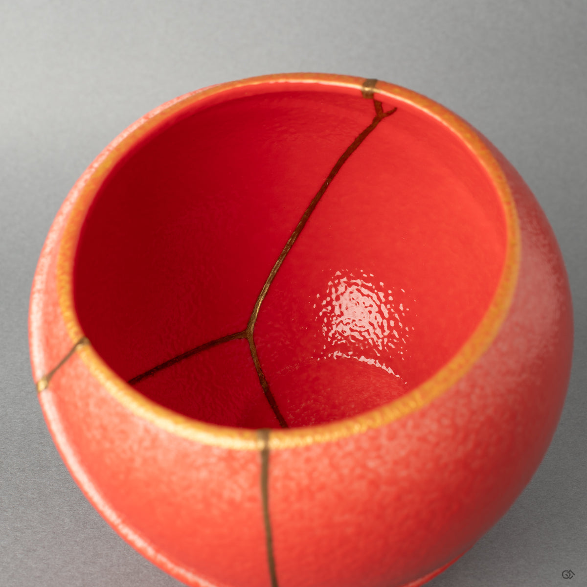 The gold line curves within the bowl, a gesture of kintsugi that offers healing through art to the fractured ceramic body.