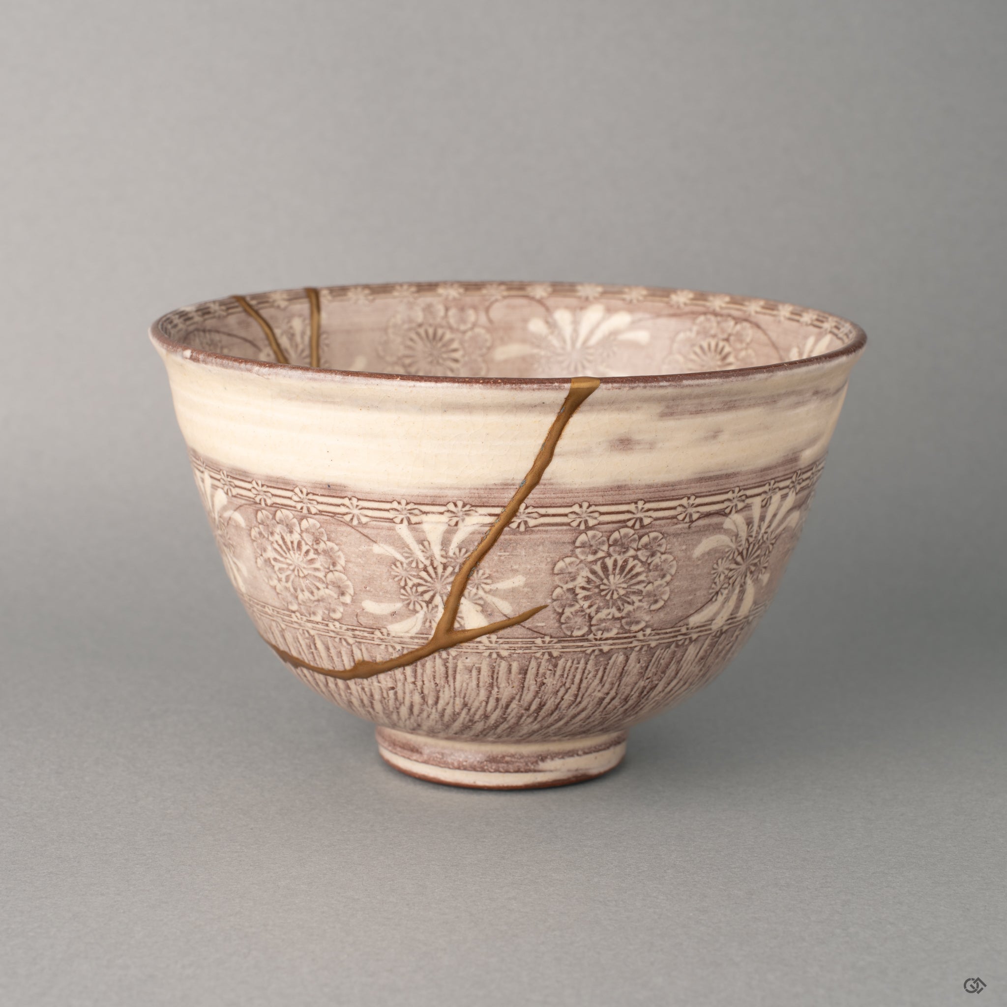 Light rests on gold kintsugi seams crossing this Kyoto bowl, Mishima textures soft beneath, a moment of contemplation held.