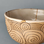 A delicate 24K gold Kintsugi restoration graces a chipped portion along the rim of the Kyoto matcha bowl, highlighting the beauty of imperfection.