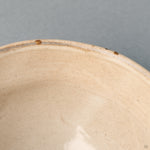 A close-up of the Kyoto matcha bowl's rim, where two small, natural chips reveal the organic texture of the underlying ceramic body.