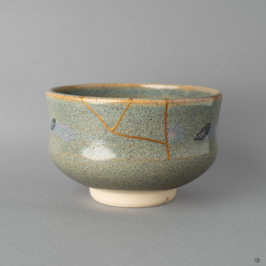 Front view of a Kyoto matcha bowl restored with urushi and 24k gold kintsugi, embodying heritage luxury and craft.