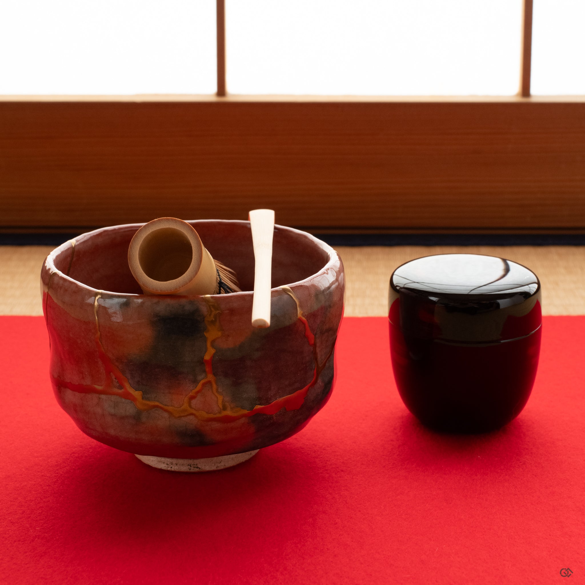 Kyoto ware kintsugi tea bowl on red felt, its 24k gold repair inviting a moment of contemplation and a moment of connection.