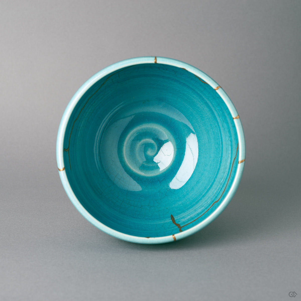 From above, gold kintsugi lines fan across the turquoise rim of the Kyoto bowl, restorative beauty in plain view.
