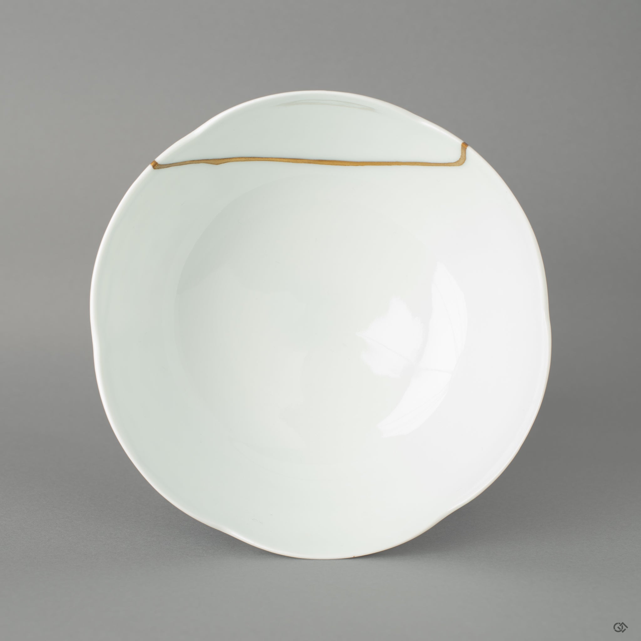 Top view of a Nabeshima matcha bowl repaired with 24k gold kintsugi using urushi lacquer, embodying wabi-sabi elegance.