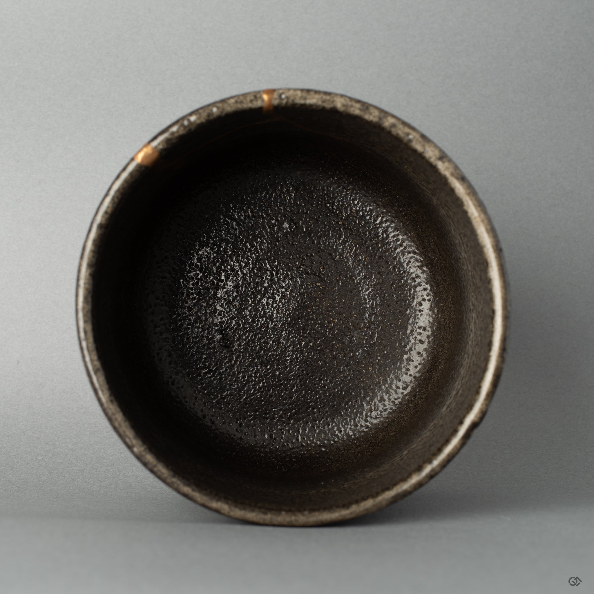 Top view of a Shigaraki matcha bowl with gold kintsugi seams, each line a story in every seam of this restored piece.