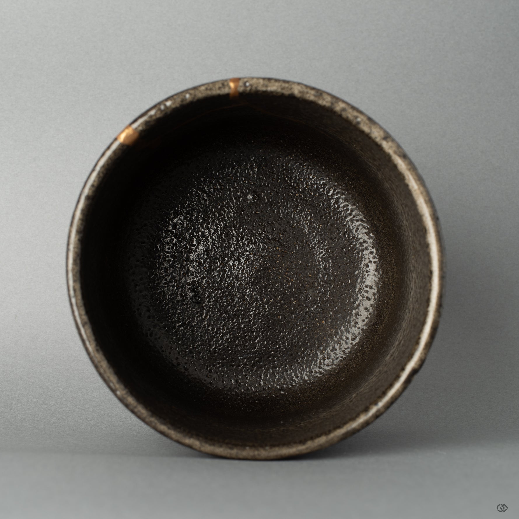Top view of a Shigaraki matcha bowl with gold kintsugi seams, each line a story in every seam of this restored piece.