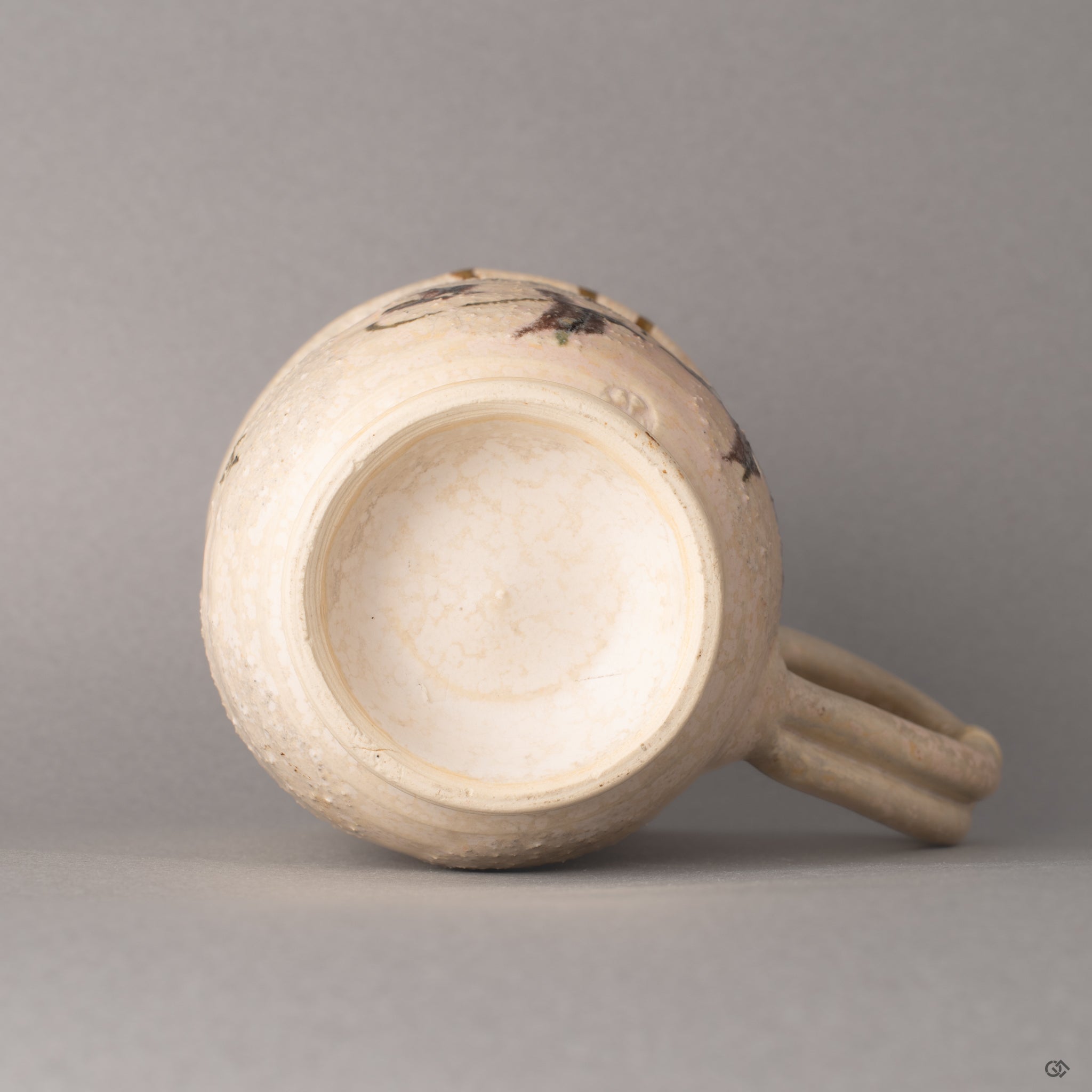 The base of this Kyoto kintsugi mug, where the foot ring meets glazed clay, history made visible in its foundation.