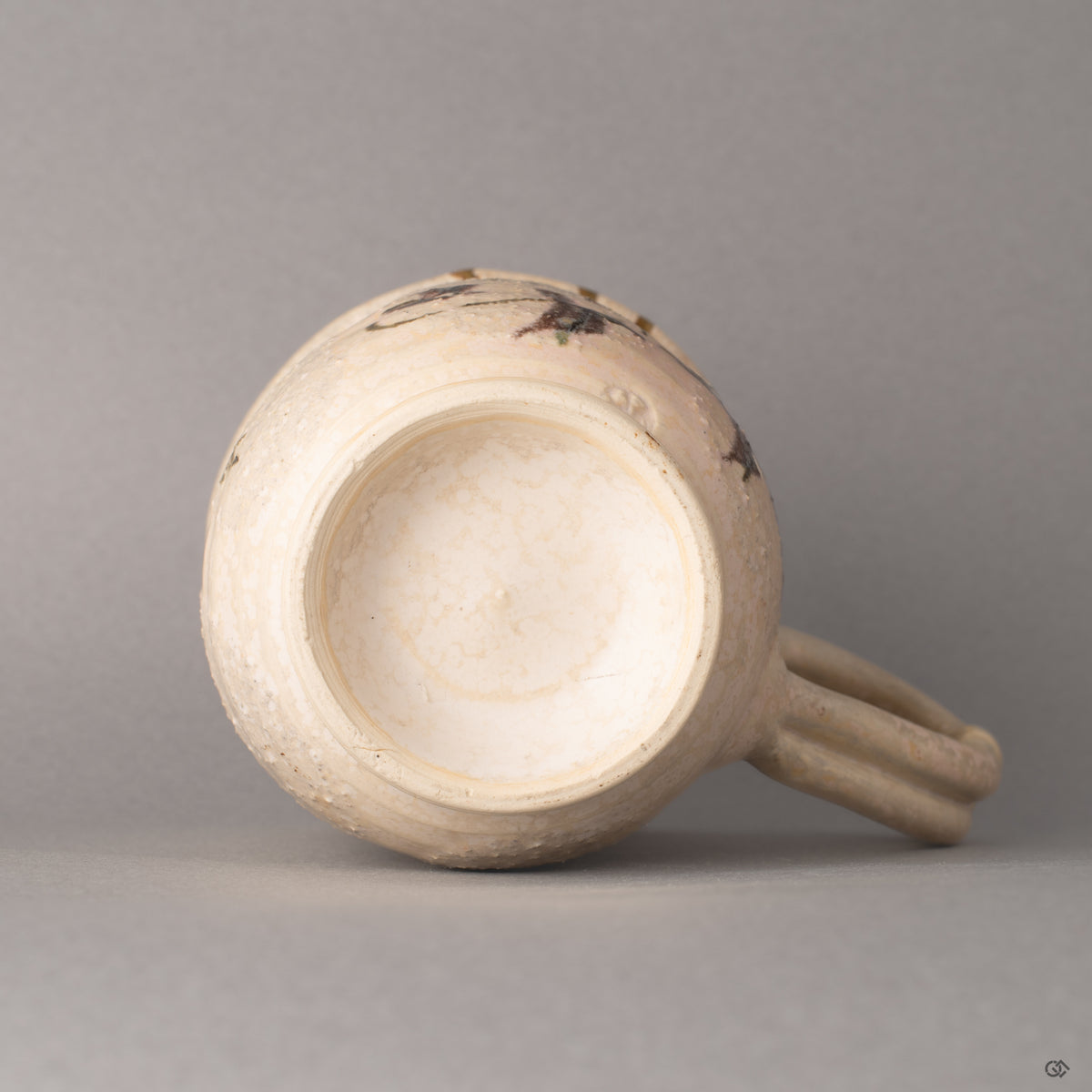 The base of this Kyoto kintsugi mug, where the foot ring meets glazed clay, history made visible in its foundation.
