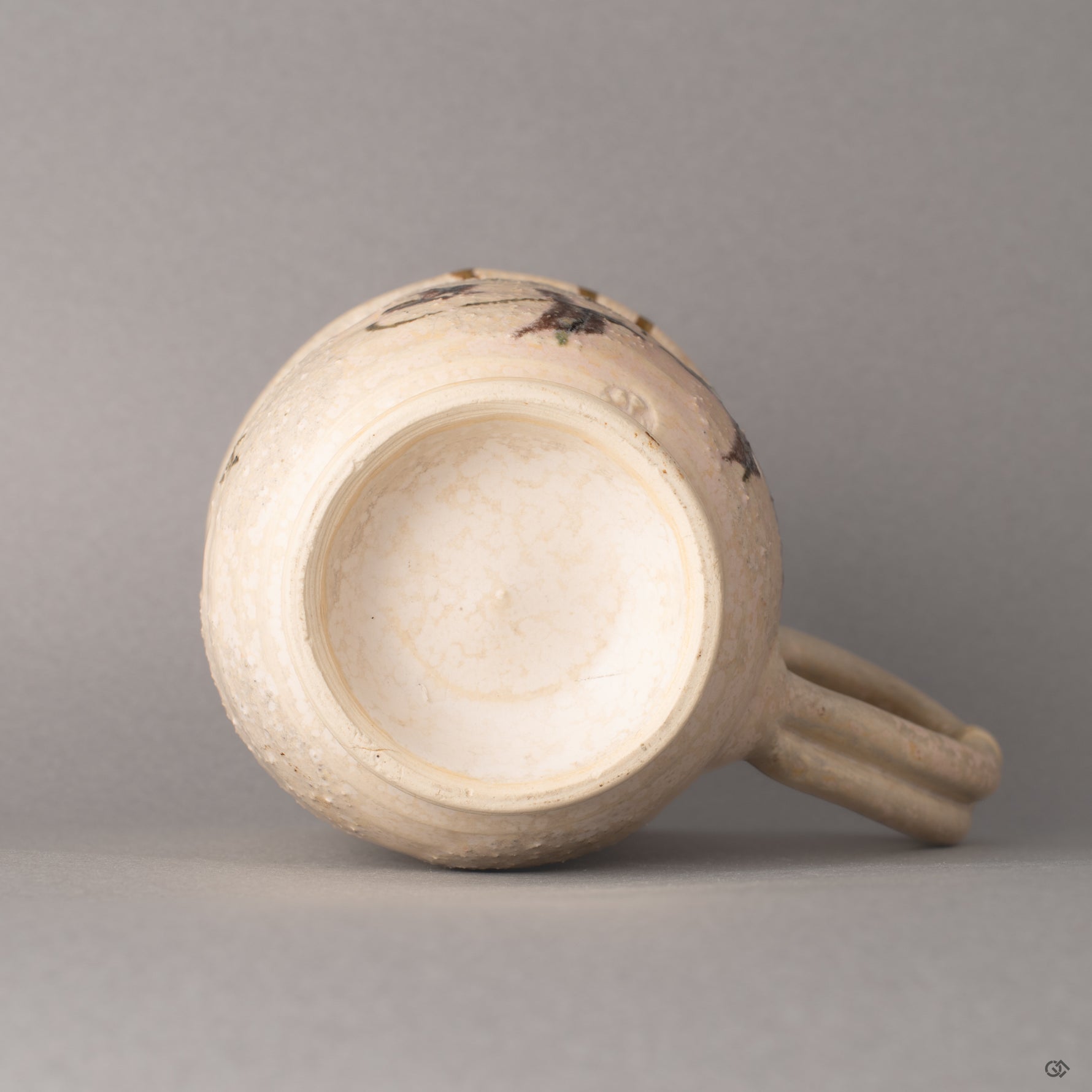 The base of this Kyoto kintsugi mug, where the foot ring meets glazed clay, history made visible in its foundation.