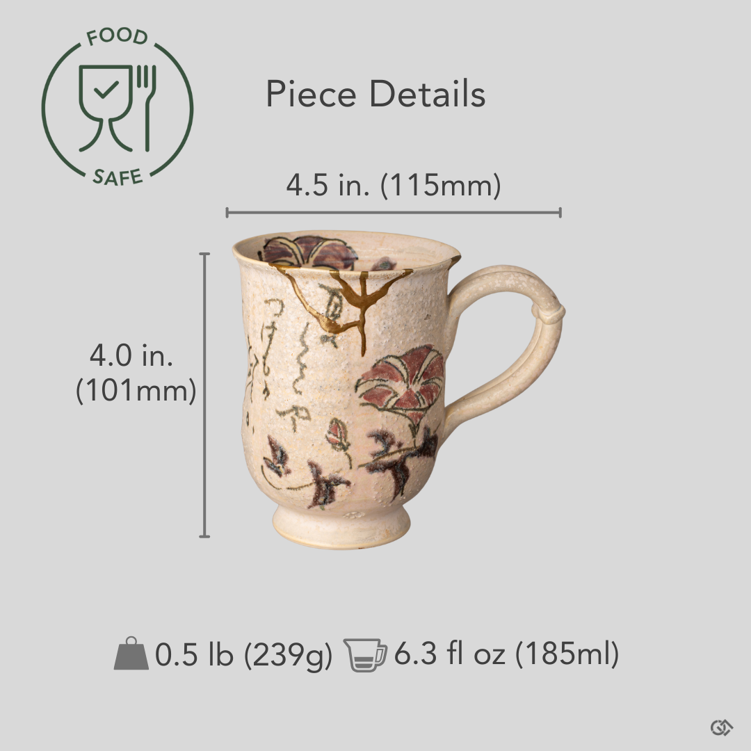 A hand cradles this Kyoto kintsugi mug, showing its scale and the gold seams that speak of slow craft and care.