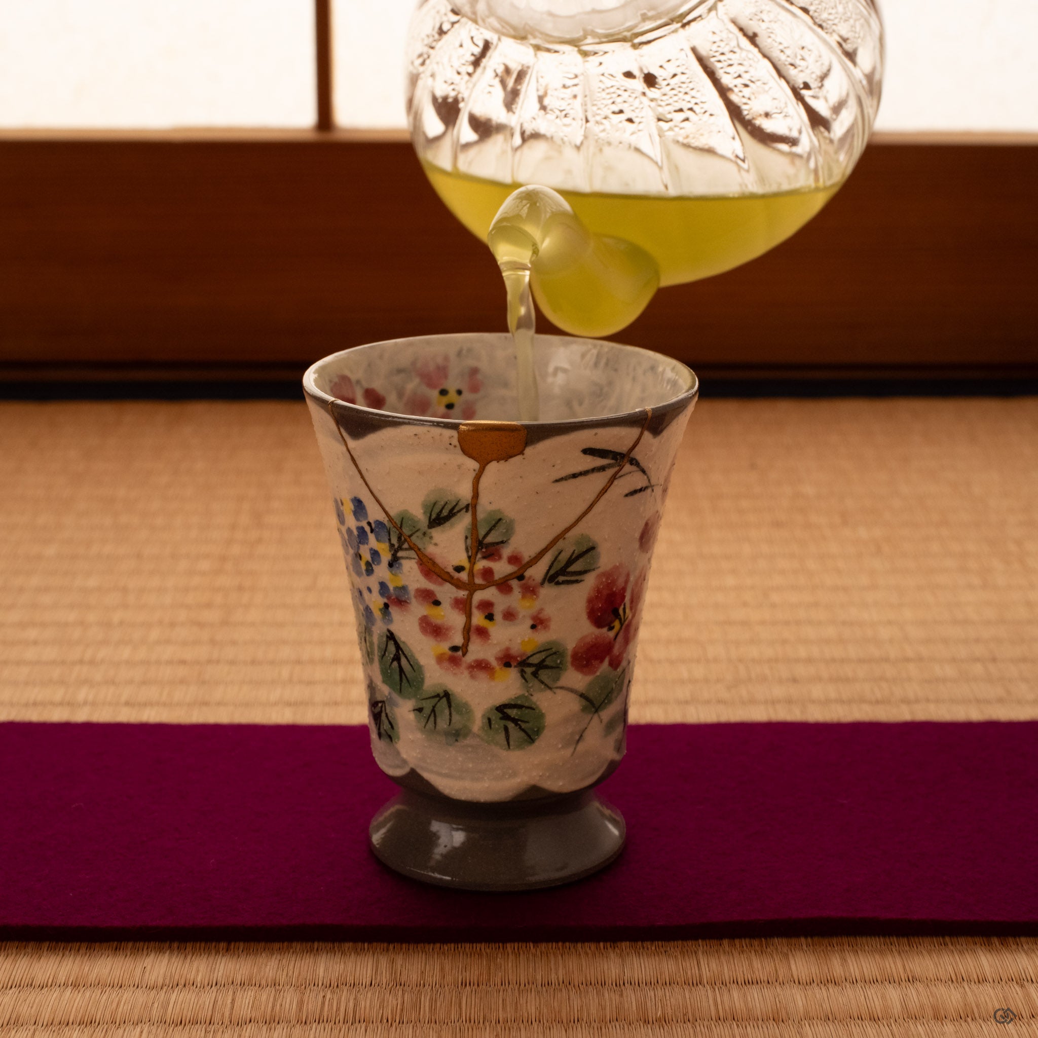 Resting on tatami, this kintsugi mug holds tea and morning light, an invitation to pause within intentional living.