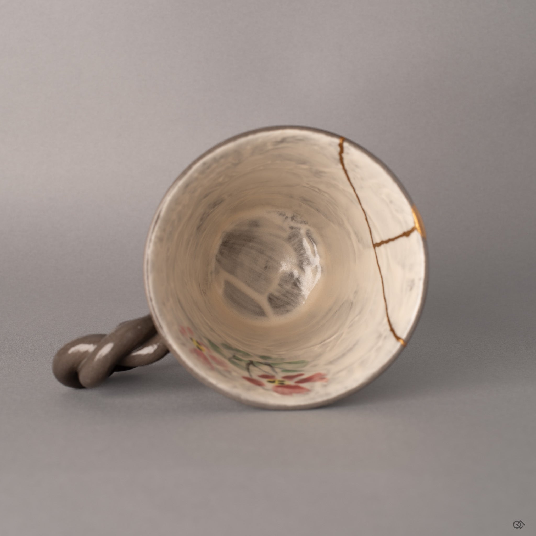 Looking into the mug from above, kintsugi lines converge like quiet rivers, marking where fractures became history made visible.