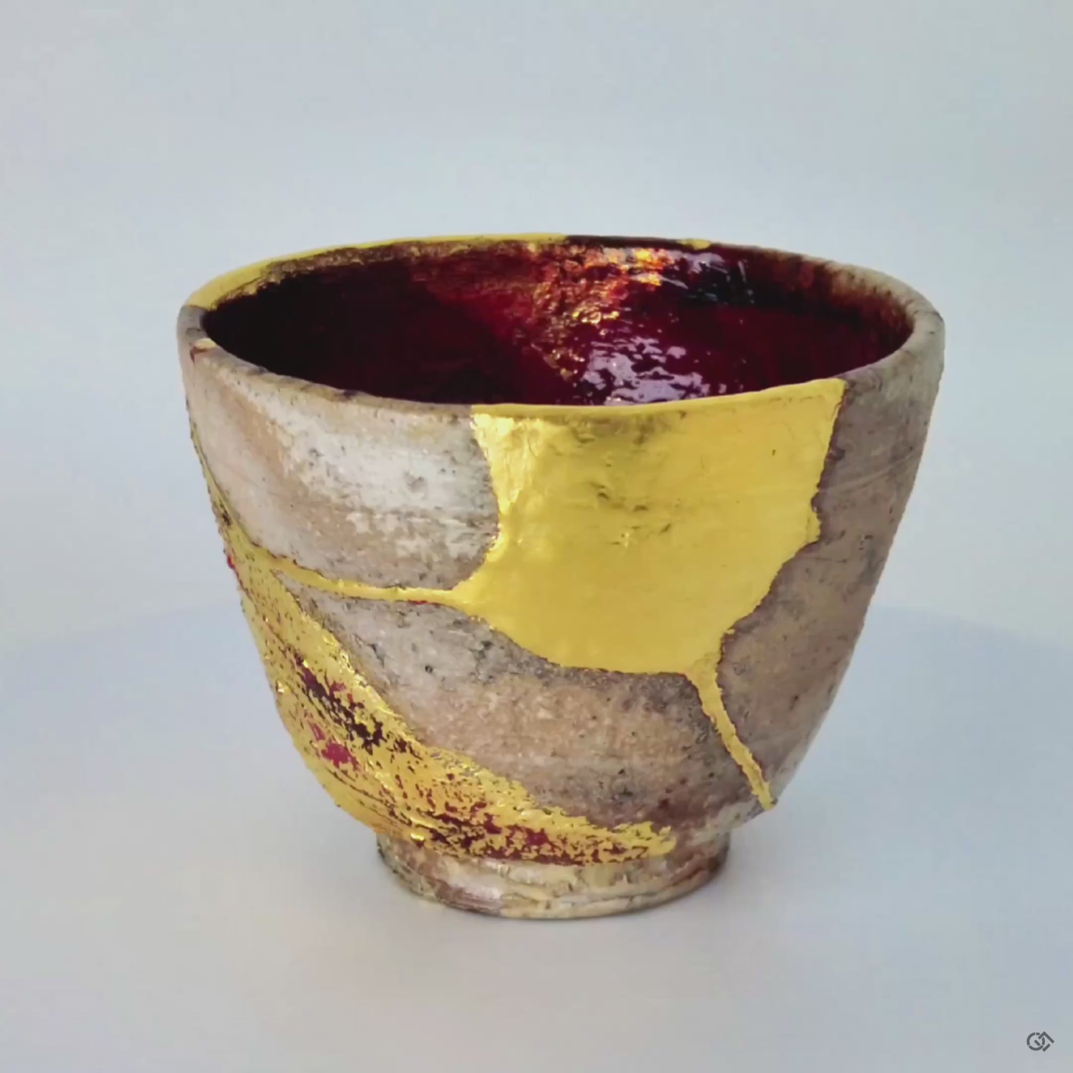 A close-up of the gold leaf repair meeting the coarse Shigaraki clay, creating a tactile history that speaks of the cups journey and renewal.