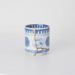 Rotation video of a kintsugi sake cup in Ko-Imari porcelain, natural urushi and 24K gold seams passing between its painted windows.