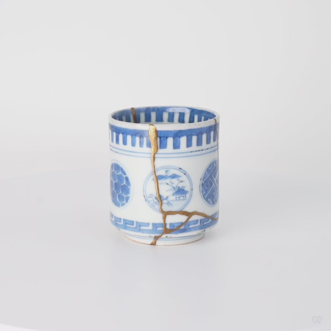 Rotation video of a kintsugi sake cup in Ko-Imari porcelain, natural urushi and 24K gold seams passing between its painted windows.