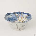 Rotating view of a Ko-Imari bowl in blue-and-white porcelain with 24K gold and pure silver kintsugi seams, turning to show the full restoration.
