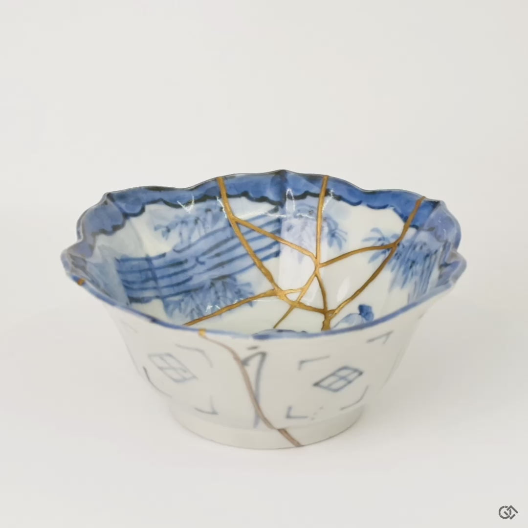 Rotating view of a Ko-Imari bowl in blue-and-white porcelain with 24K gold and pure silver kintsugi seams, turning to show the full restoration.
