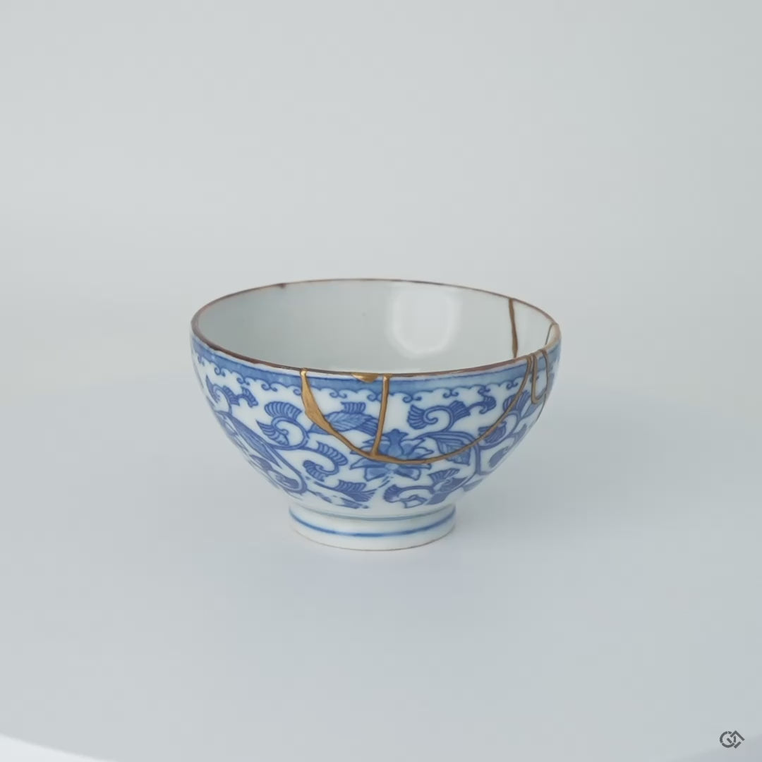 Rotation video of an Edo-period Ko-Imari porcelain sake cup with karakusa vines, showing its 24K gold kintsugi restoration in natural urushi all round.