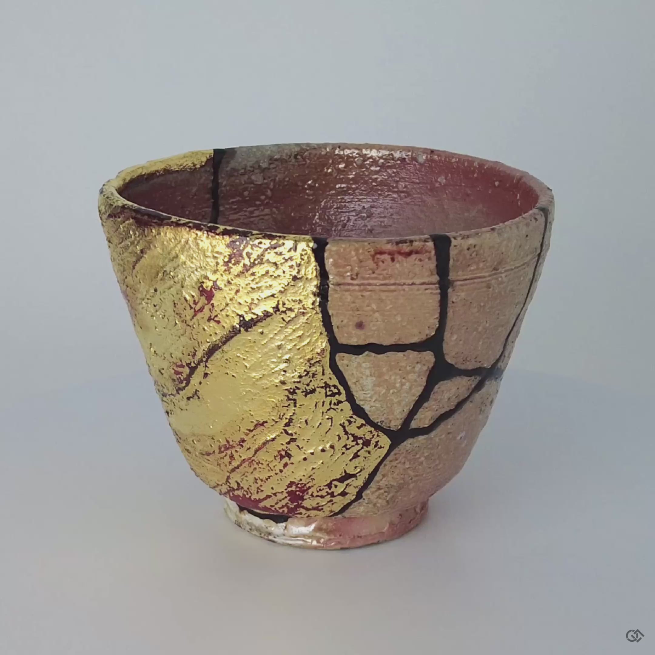 A 360-degree video of the mixed-media kintsugi cup, showcasing its visible resilience and the harmony of its complex, artistic repair.